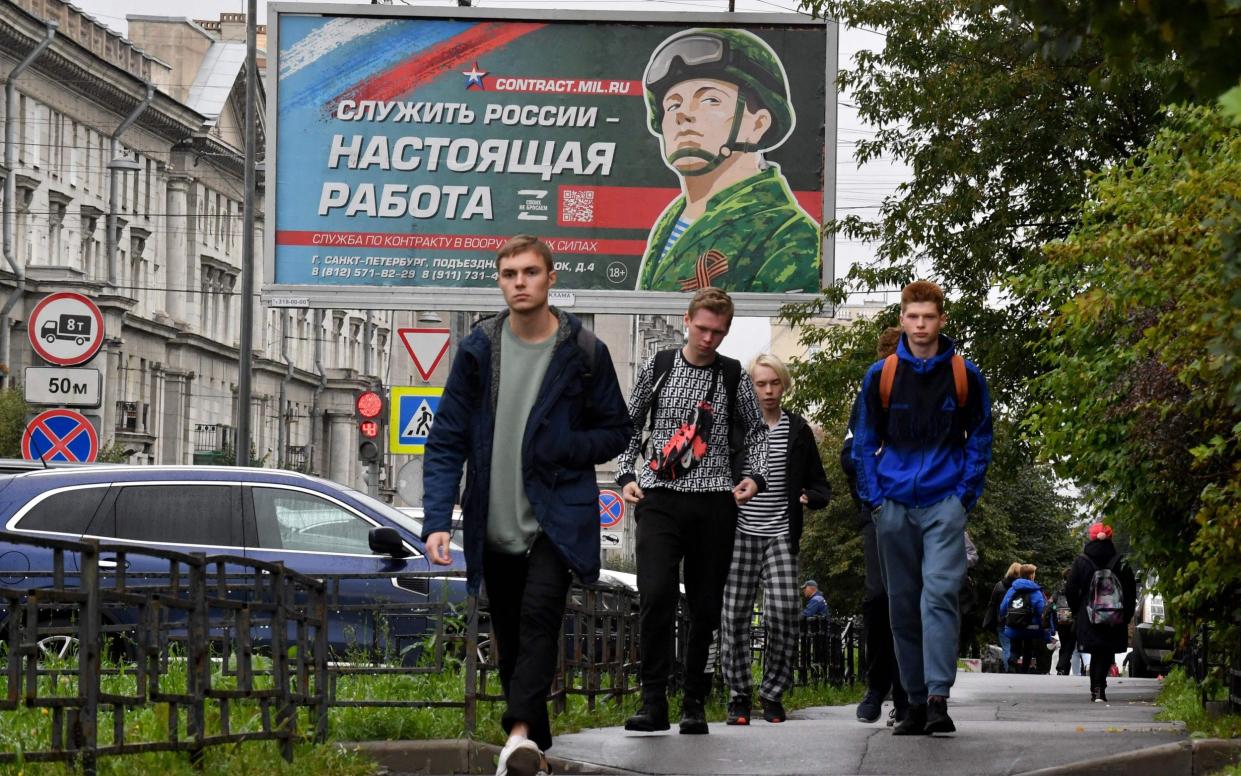 Kremlin propaganda has portrayed Russian men who fled abroad as selfish cowards, compared to the 'real men' who signed up - Olga Maltseva/AFP via Getty Images