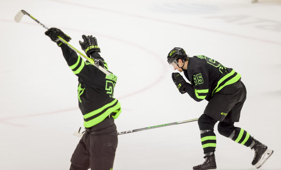 Dallas Stars players Thomas Harley (55) and Jason Robertson (21) celebrate Harley's game-winning goal during overtime in an NHL hockey game against the Washington Capitals, Saturday, Jan. 27, 2024, in Dallas. (AP Photo/Gareth Patterson)