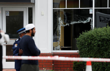 Members of Muslim religious groups say prayers at the site of the shooting outside Linwood Mosque in Christchurch, New Zealand March 18, 2019. REUTERS/Edgar Su