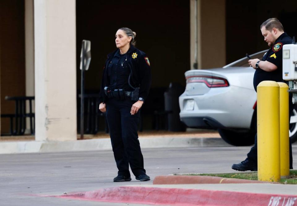 Tarrant County sheriff’s deputies wait outside the emergency room at John Peter Smith Hospital in Fort Worth, where an injured deputy was taken after being shot at the Fort Worth Community Credit Union on Monday, Nov. 27, 2023.
