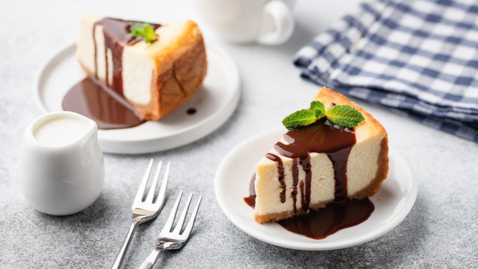 cheesecake with chocolate sauce and cup of coffee