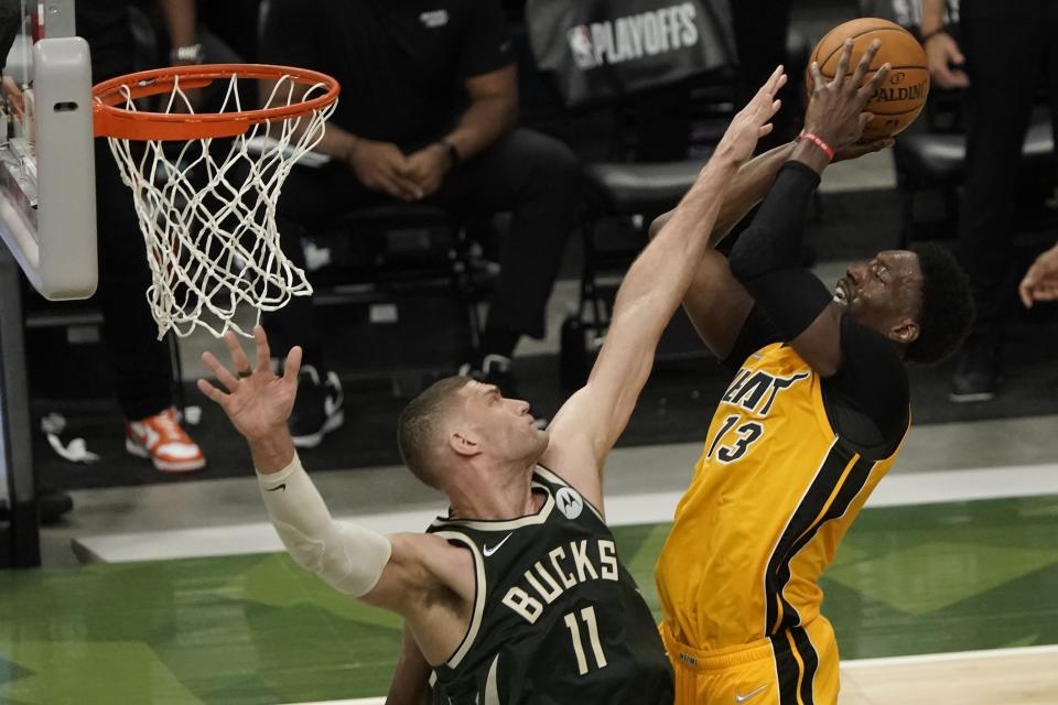 Miami Heat's Bam Adebayo shoots over Milwaukee Bucks' Brook Lopez during the first half of Game 1 of their NBA basketball first-round playoff series Saturday, May 22, 2021, in Milwaukee. (AP Photo/Morry Gash)