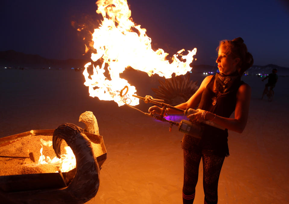 <p>Diggy Shakes lights the art installation Efflorescence as approximately 70,000 people from all over the world gathered for the annual Burning Man arts and music festival in the Black Rock Desert of Nevada, Aug. 28, 2017. (Photo: Jim Urquhart/Reuters) </p>