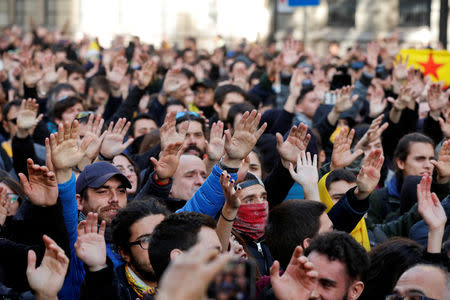 People raise hands as they attend a protest against Spain's cabinet meeting, in Barcelona, Spain, December 21, 2018. REUTERS/Albert Gea