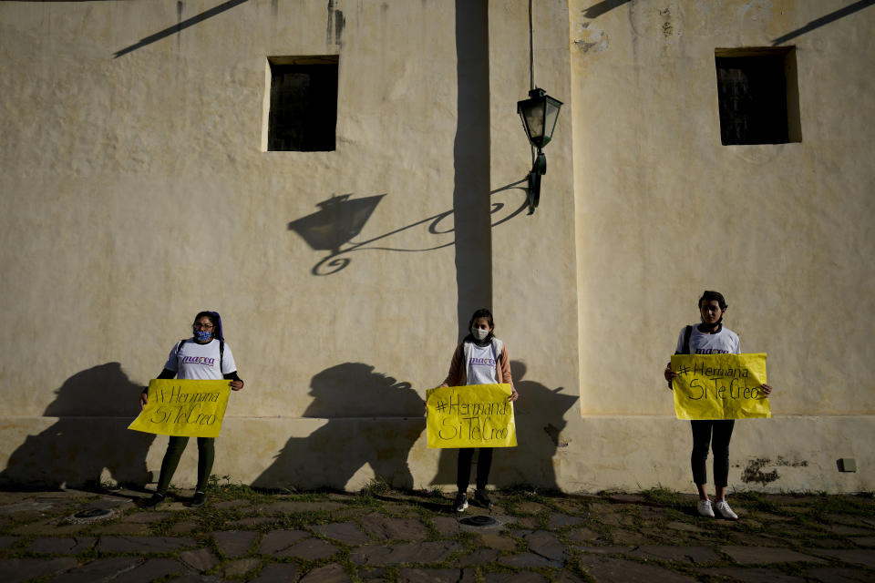 Women hold banner signs with messages that read in Spanish; "Sister, I do believe you", during a protest outside the San Bernardo Convent, in Salta, Argentina, Tuesday, May 3, 2022. Several feminist groups protested in support of the eighteen cloistered nuns from the convent who have made a formal allegation against the Archbishop Mario Cargnello of Salta and two other members of the church for alleged physical and psychological gender violence. (AP Photo/Natacha Pisarenko)