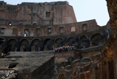 Tourists stand on a balcony as they visit the Colosseum in Rome, Italy, June 28, 2016. Picture taken June 28, 2016. REUTERS/Alessandro Bianchi