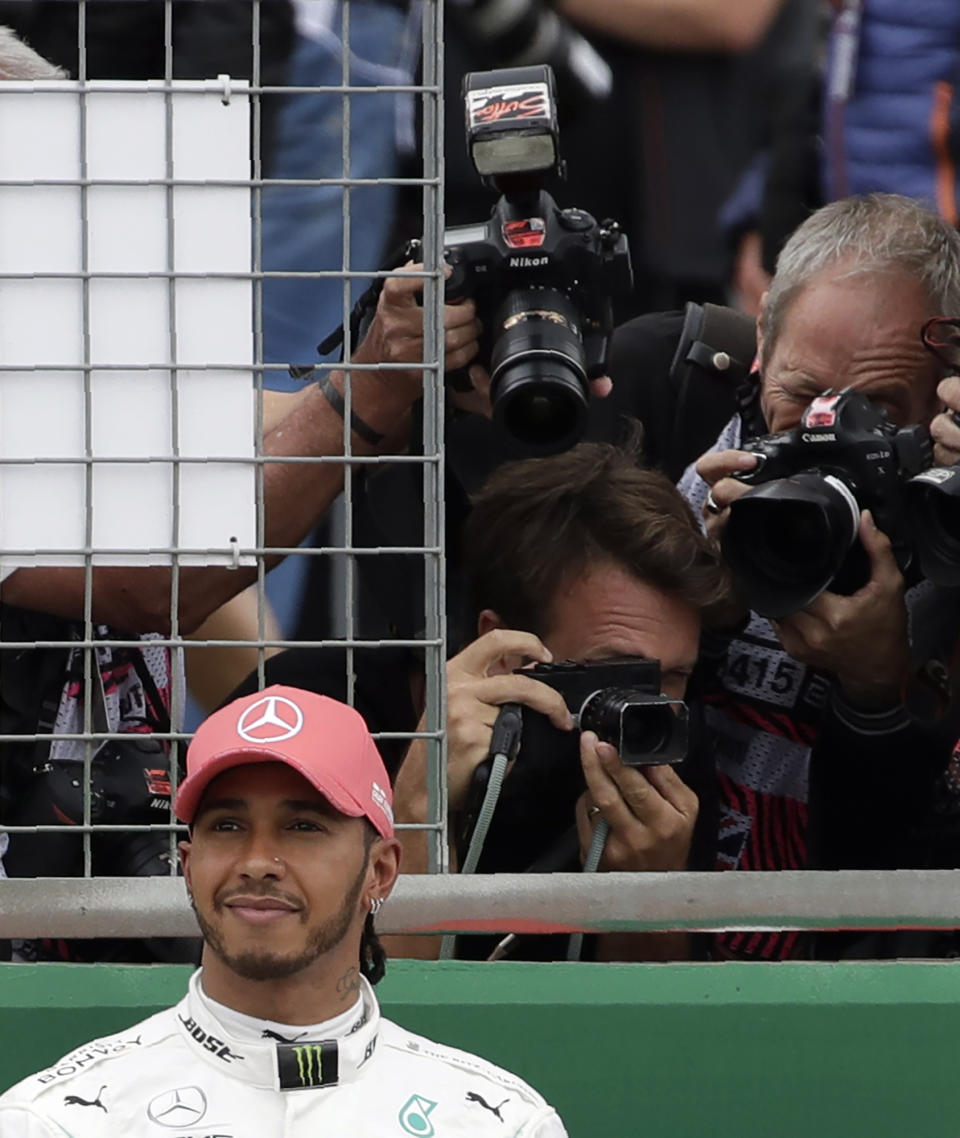 Second placed Mercedes driver Lewis Hamilton of Britain smiles after the qualifying session at the Silverstone racetrack, in Silverstone, England, Saturday, July 13, 2019. The British Formula One Grand Prix will be held on Sunday. (AP Photo/Luca Bruno)