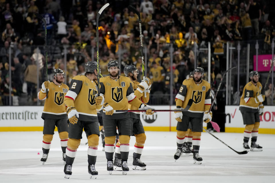 Vegas Golden Knights players celebrate after Game 1 of the NHL hockey Stanley Cup Finals against the Florida Panthers, Saturday, June 3, 2023, in Las Vegas. The Vegas Golden Knights defeated the Panthers 5-2. (AP Photo/John Locher)
