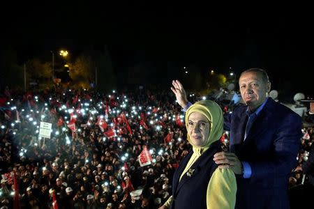 Turkish President Tayyip Erdogan, accompanied by his wife Emine Erdogan, addresses his supporters in Istanbul, Turkey, late April 16, 2017. Yasin Bulbul/Presidential Palace/Handout via REUTERS