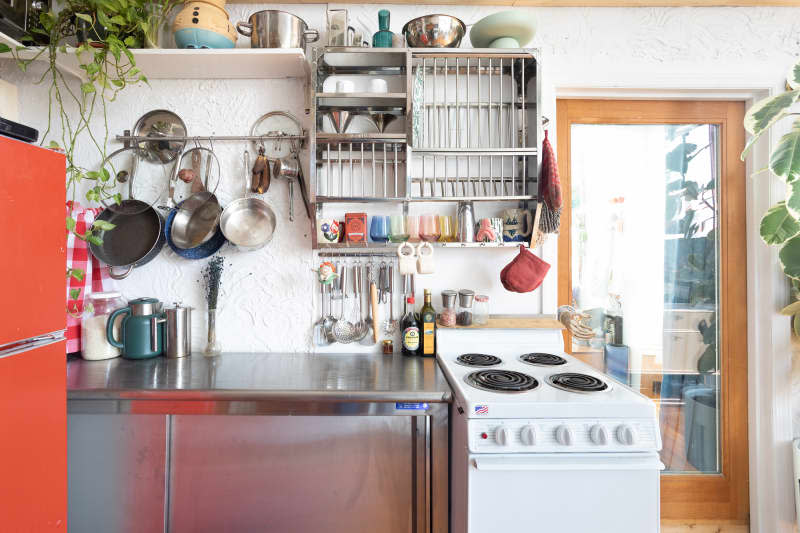 Chrome organizing rack in eclectic apartment.