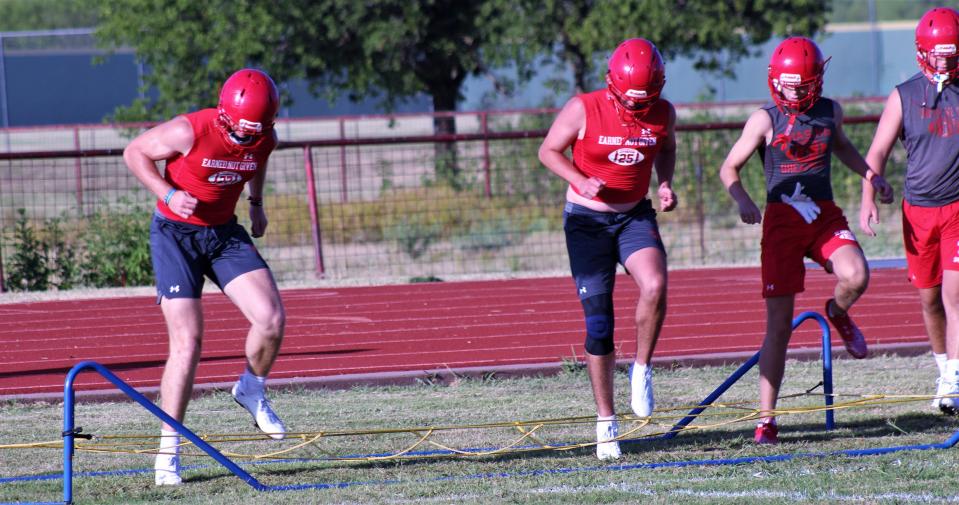 Albany players worked through give agility stations to begin workouts after stretching. Coaches encouraged players to pick up their legs and pump their arms.