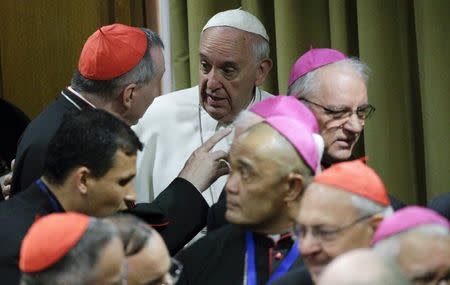 Pope Francis talks with cardinals as he leads the synod on the family in the Synod hall at the Vatican, October 5, 2015. REUTERS/Max Rossi