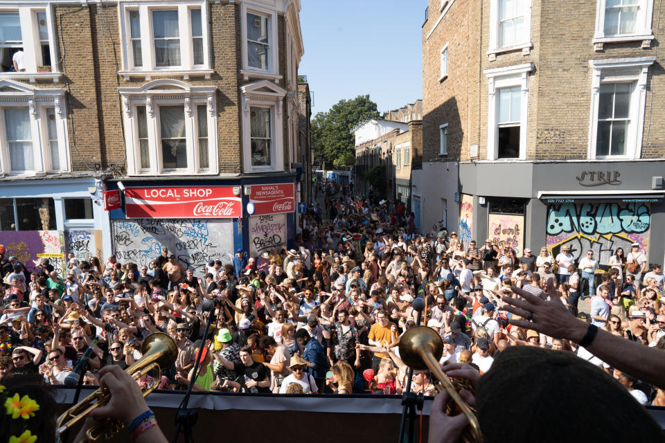 People dance on the streets of Notting Hill, west London, during the carnival.