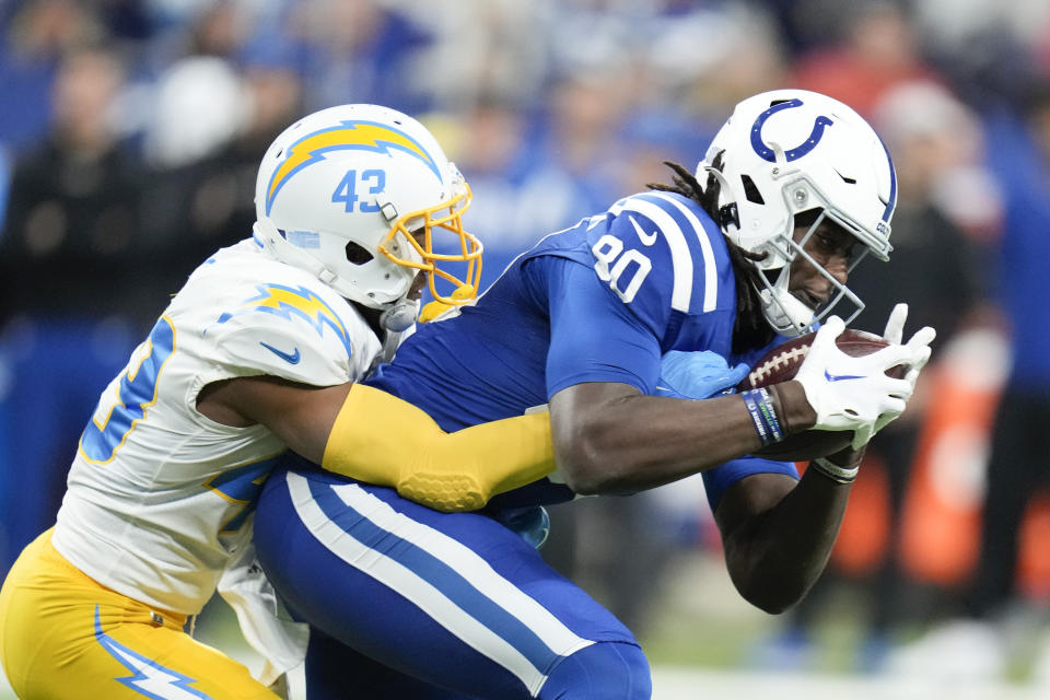 Indianapolis Colts' Jelani Woods (80) makes a catch against Los Angeles Chargers' Michael Davis (43) during the first half of an NFL football game, Monday, Dec. 26, 2022, in Indianapolis. (AP Photo/Michael Conroy)