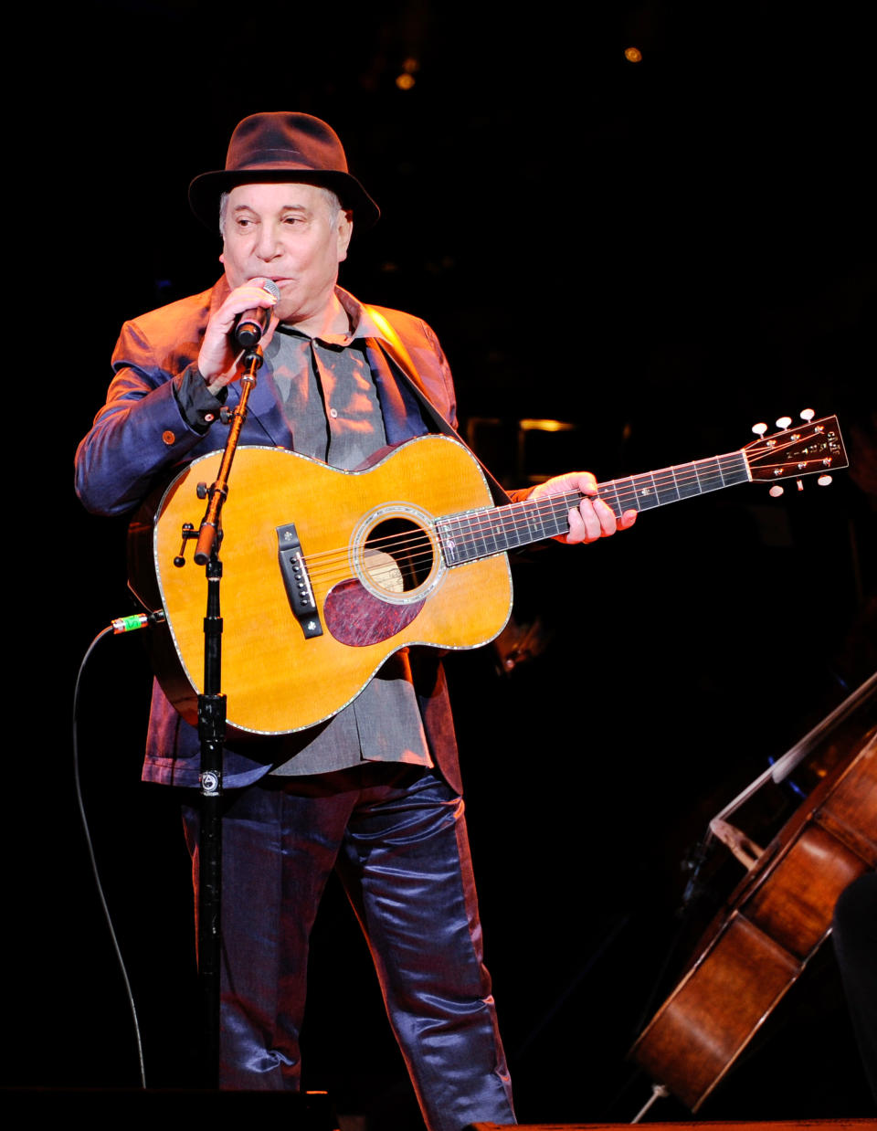 FILE - In this Thursday, April 17, 2014, file photo, musician Paul Simon performs at the 25th Anniversary Rainforest Fund benefit concert at Carnegie Hall in New York. Simon performed more than a dozen songs Wednesday night, May 7, 2014, at the Beacon Theatre in New York, where he was honored at the 2014 NYU Steinhardt Vision Award Gala. It was Simon's first public appearance since he and wife Edie Brickell were arrested on disorderly conduct charges. (Photo by Evan Agostini/Invision/AP, File)