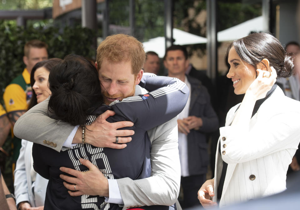 Prince Harry hugs the UK team’s vice captain Michelle Turner on Sunday. Photo: Getty