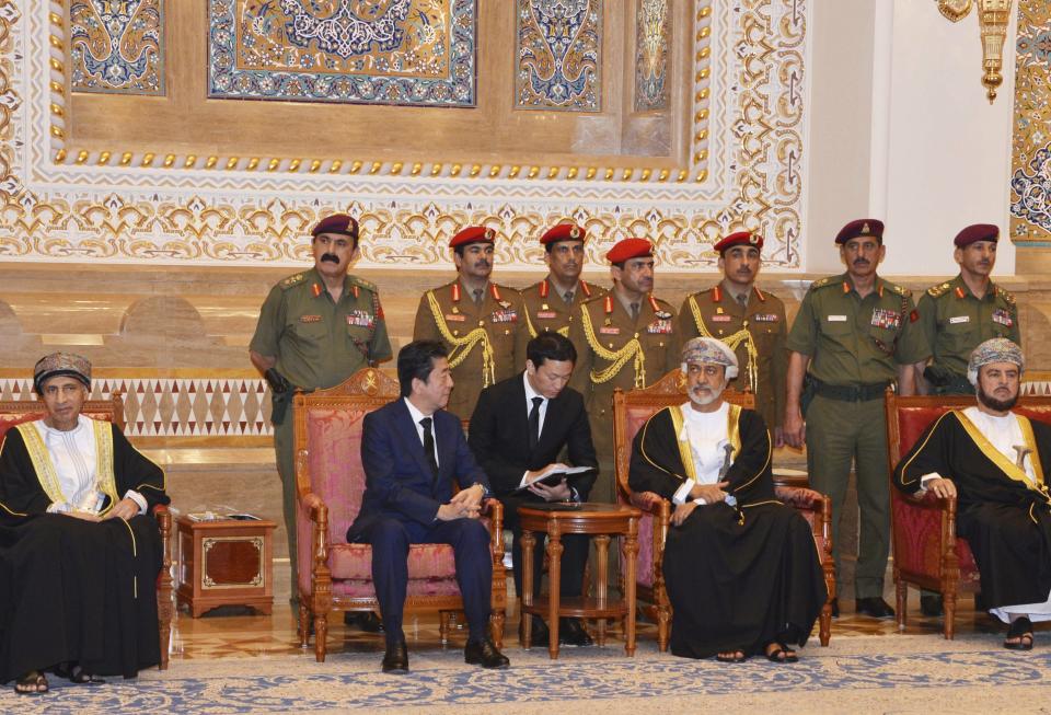 In this photo made available by Oman News Agency, Oman's Sultan Haitham bin Tariq Al Said, center right, receives Japan's prime minister Shinzo Abe after his arrival in Muscat, Oman, Tuesday, Jan. 14, 2020.(Oman News Agency via AP)