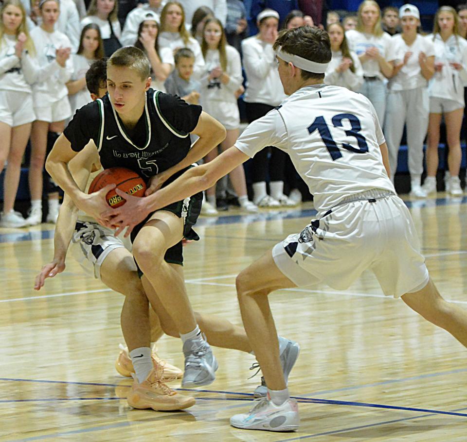 Clark-Willow Lake's Bo Begeman splits Great Plains Lutheran defenders Brody Scharlemann and Alex Heil (13) during their Region 2A quarterfinal boys basketball game on Tuesday, Febg. 27, 2024 in Watertown. Clark-Willow Lake pulled away in the fourth quarter for a 51-39 win.