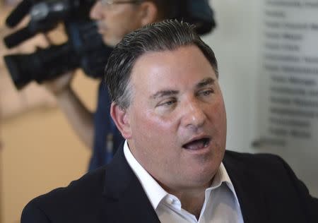 Suspended Miami Lakes Mayor Michael Pizzi talks to reporters in the lobby of Miami Lakes Town Hall in Miami Lakes, Florida August 18, 2014. REUTERS/Zachary Fagenson