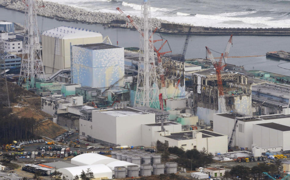Tsunami-crippled four reactors, from left, Unit 1 to Unit 4, are seen at Fukushima Dadi-ichi nuclear power plant in Okuma, Fukushima Prefecture, Japan Sunday, March 11, 2012. Japan on Sunday was remembering the massive earthquake and tsunami that struck the nation a year ago, killing just over 19,000 people and unleashing the world's worst nuclear crisis in a quarter century. The photo was taken about three kilometers (1.9 miles) away from the plant. (AP Photo/Kyodo News) JAPAN OUT, MANDATORY CREDIT, NO LICENSING IN CHINA, HONG KONG, JAPAN, SOUTH KOREA AND FRANCE