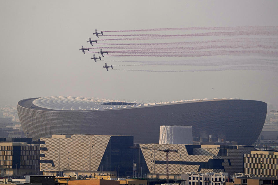 A flypast of takes place over the Lusail Stadium in Lusail, Qatar, where the World Cup final soccer match between Argentina and France is going to be played on Sunday, Dec. 18, 2022. (AP Photo/Pavel Golovkin)