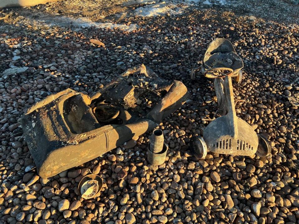 A burned Garton Toy next to a burned Kidillac family heirloom found in the remains of Baer's former home on Jan 9, 2022/