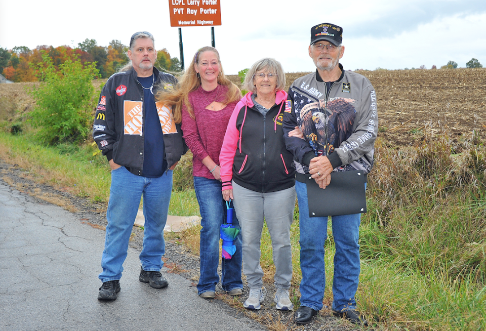 Family members stand near the sign of the newly dedicated road segment, the PFC Roy Porter and LCpl Larry Porter Memorial Highway. L-R: Roy Porter (nephew), Laura Beckelhimer (niece), Dotty (sister-in-law) and Jerry Porter (brother).