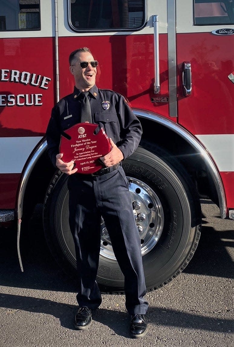 Lt. Jeremy Dugan of the Farmington Fire Department reacts after receiving the New Mexico Firefighter of the Year award during an April 15 ceremony in Albuquerque.