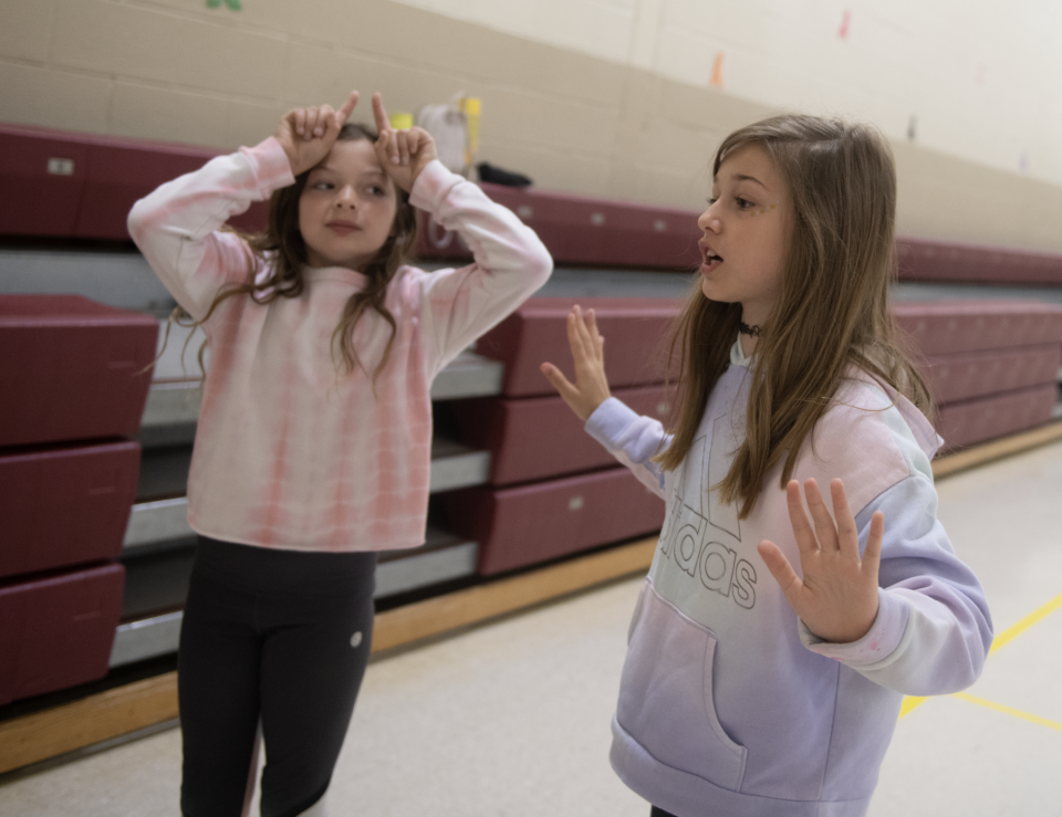 Emma Mullen, 9, and Maddy Miller, 9, act out the word "dinosaurs" during a non-verbal activity as part of Southeast intermediate and primary schools' Abilities Week.