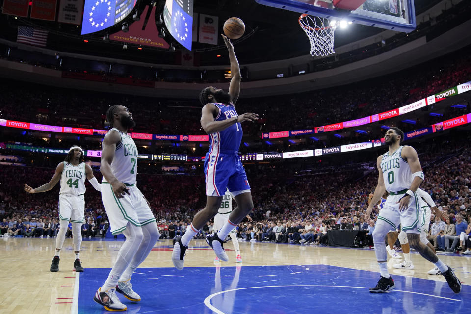 Philadelphia 76ers' James Harden (1) shoots against Boston Celtics' Jaylen Brown (7) and Jayson Tatum (0) during the second half of Game 6 of an NBA basketball playoffs Eastern Conference semifinal, Thursday, May 11, 2023, in Philadelphia. (AP Photo/Matt Slocum)