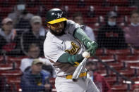 Oakland Athletics' Elvis Andrus hits a single to score Matt Chapman during the seventh inning of the team's baseball game against the Boston Red Sox, Tuesday, May 11, 2021, in Boston. (AP Photo/Mary Schwalm)