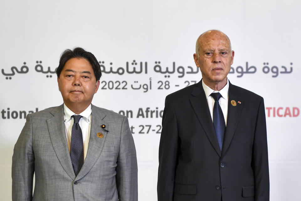Tunisia's President Kais Saied, right, and Japan's Foreign Minister Yoshimasa Hayashi pose for a photo during the eighth Tokyo International Conference on African Development (TICAD) in Tunisia's capital Tunis on Saturday, Aug. 27, 2022. African heads of state, representatives of international organizations and private business leaders are in Tunisia this weekend for the eighth iteration of the Tokyo International Conference on African Development, a triennial event launched by Japan to promote growth and security in Africa. (Fethi Belaid/Pool Photo via AP)