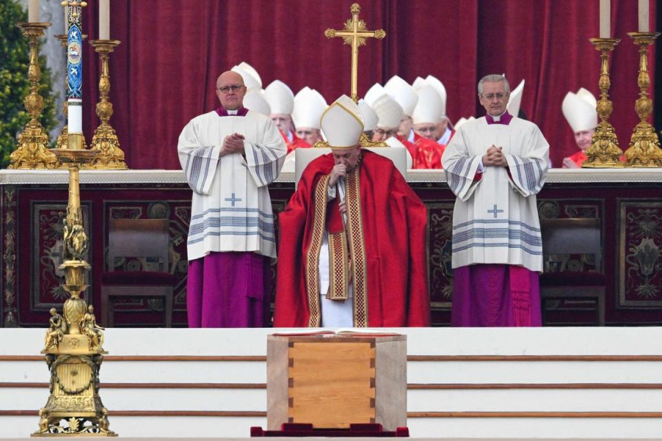 Pope Francis (C) reacts by the coffin of Pope Emeritus Benedict XVI during his funeral mass at St. Peter's square in the Vatican (AFP via Getty Images)