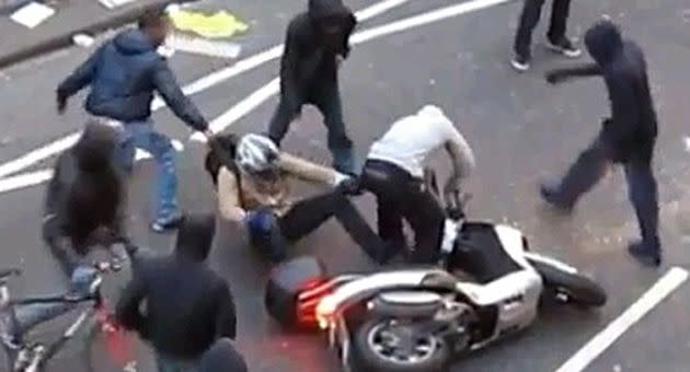 He is violently pulled off the vehicle by a hooded thug. Photo: YouTube