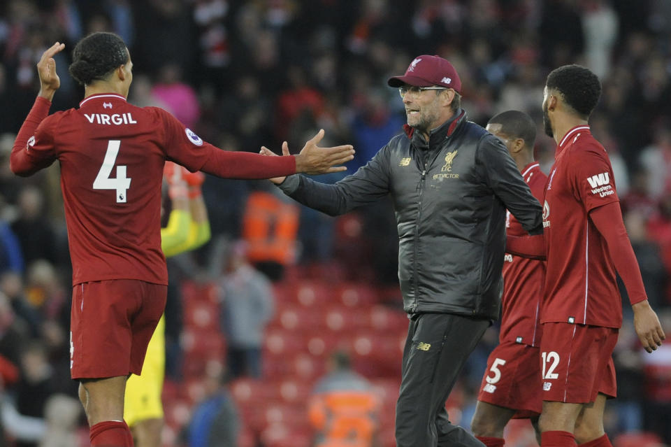 Liverpool manager Juergen Klopp congratulates Liverpool's Virgil van Dijk , left, after the English Premier League soccer match between Liverpool and Manchester City at Anfield stadium in Liverpool, England, Sunday, Oct. 7, 2018. (AP Photo/Rui Vieira)