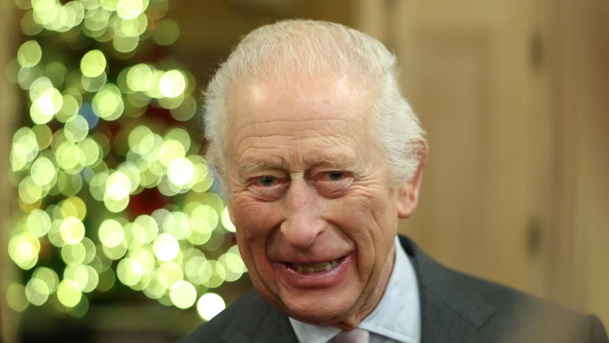 King Charles smiling in a suit