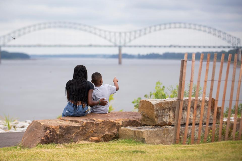 Malia Ezell and her brother Xavier Ezell, 5, look out on the Mississippi River and Hernando de Soto Bridge from the newly renovated Tom Lee Park shortly after it officially opened to the public in Downtown Memphis on Saturday, September 2, 2023.