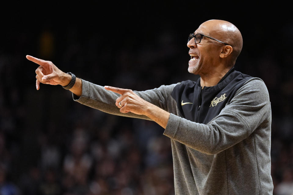 Central Florida coach Johnny Dawkins directs the team during the first half of an NCAA college basketball game against Houston, Wednesday, March 6, 2024, in Orlando, Fla. (AP Photo/John Raoux)