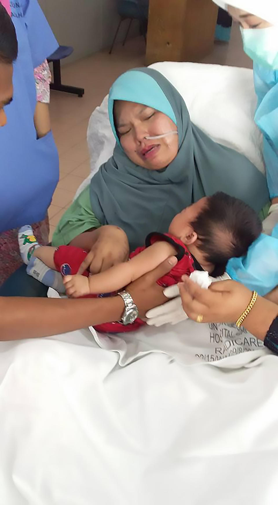 Nur Fadilla was in tears as she met her five-month-old son for the first time. Source: AsiaWire/Australscope