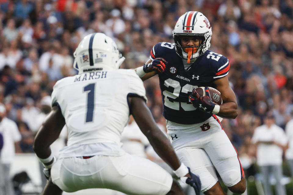 Auburn running back Jeremiah Cobb (23) carries the ball as Samford cornerback Kourtlan Marsh (1) defends during the first half of an NCAA college football game Saturday, Sept. 16, 2023, in Auburn, Ala. (AP Photo/Butch Dill)