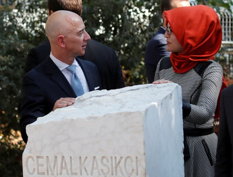 FILE PHOTO: Hatice Cengiz, fiancee of the murdered Saudi journalist Jamal Khashoggi, and Jeff Bezos, founder of Amazon and Blue Origin, talk as they attend a ceremony marking the first anniversary of Khashoggi's killing at the Saudi Consulate, in Istanbul