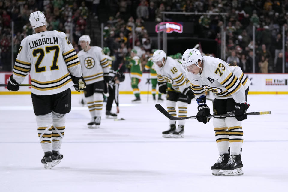 Boston Bruins defenseman Charlie McAvoy, right, skates after the team's loss to the Minnesota Wild in an NHL hockey game Saturday, Dec. 23, 2023, in St. Paul, Minn. (AP Photo/Abbie Parr)