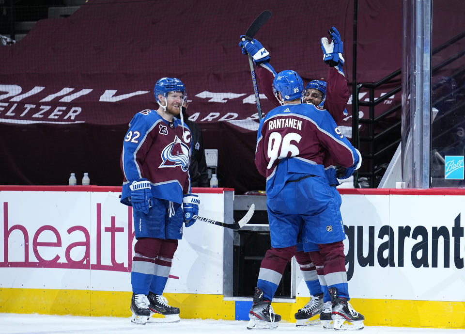 Colorado Avalanche left wing Gabriel Landeskog (92) celebrates with Pierre-Edouard Bellemare (41) and Mikko Rantanen (96) after the team's win pver the Los Angeles Kings in an NHL hockey game Thursday, May 13, 2021, in Denver. (AP Photo/Jack Dempsey)