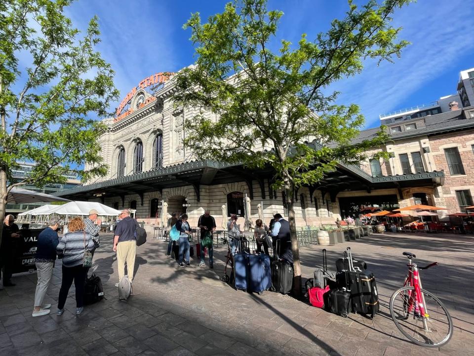 The exterior of Denver's Union Station with a group of people who will ride the Rocky Mountaineer.