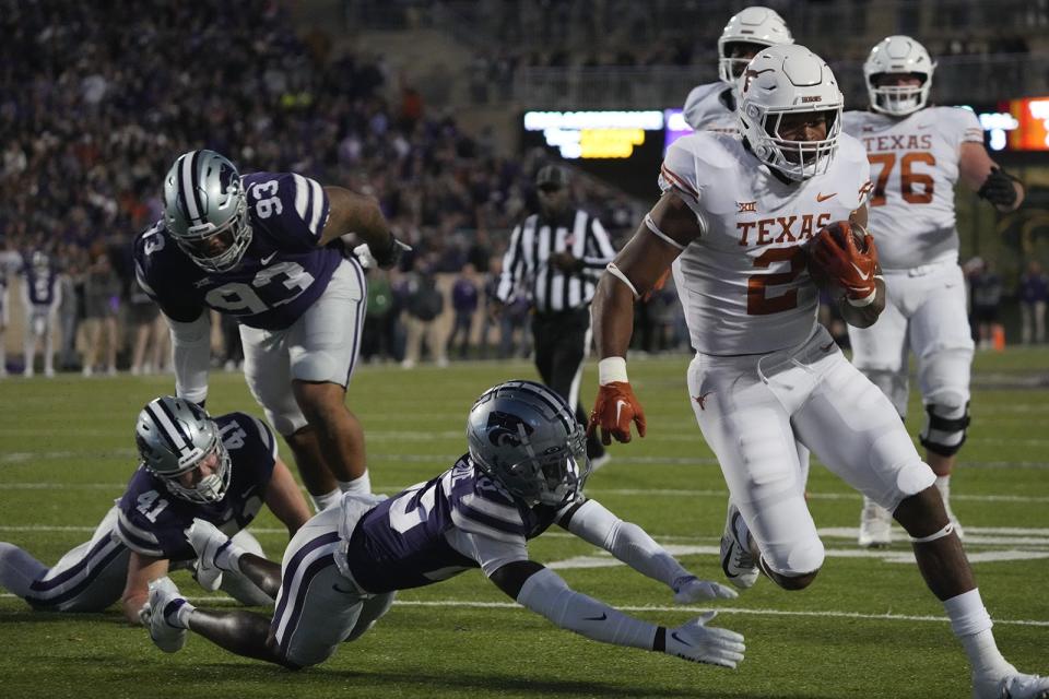 Texas running back Roschon Johnson scores on a touchdown run in the first half of the Longhorns' game at Kansas State on Saturday.