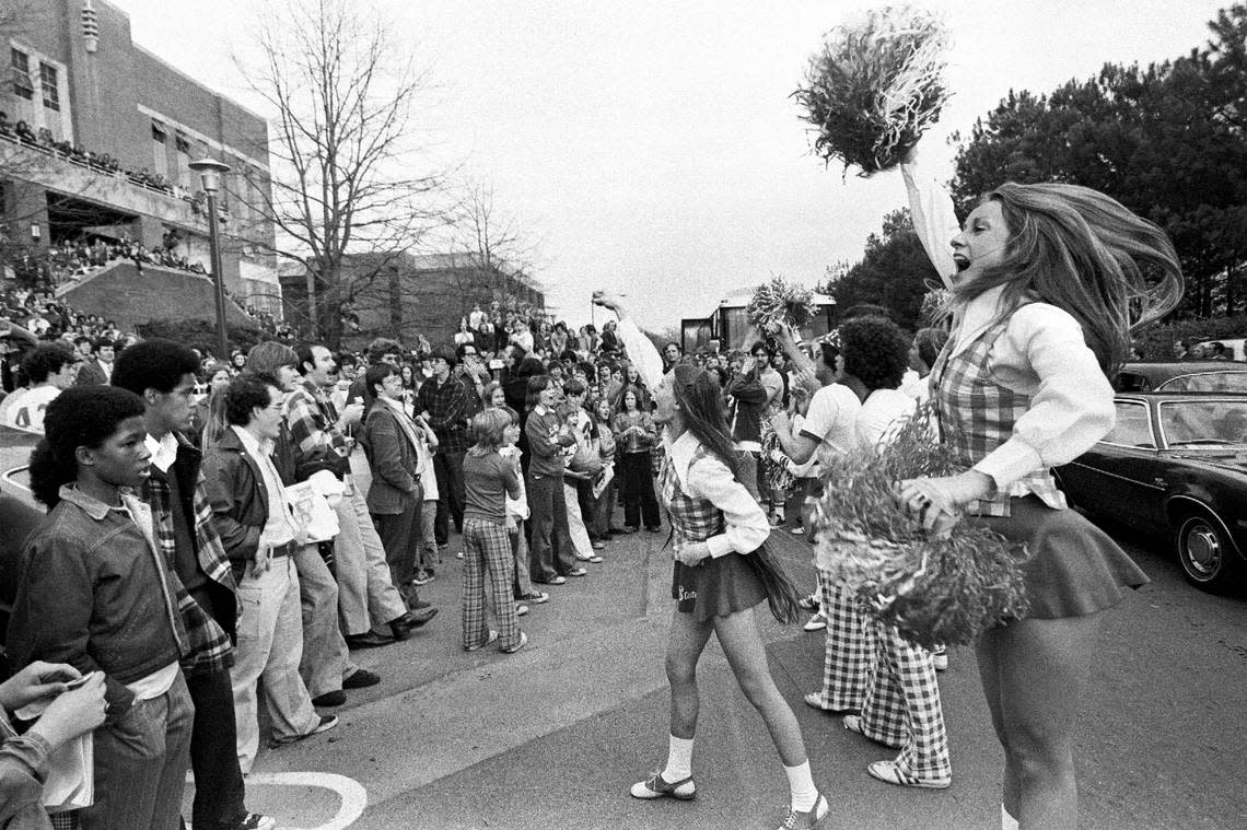 NC State cheerleaders fire up the crowd outside Reynolds Colieseum as the Wolfpack departs for the 1974 Final Four.