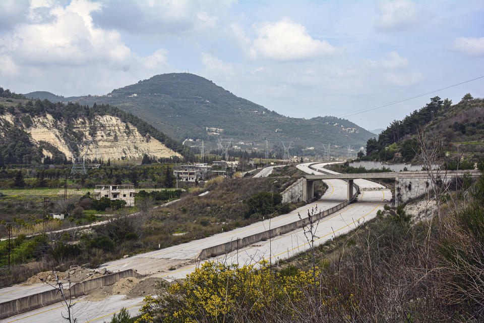 This Tuesday, March. 10, 2020 photo, released by the Syrian official news agency SANA, shows the road that links Syria's coastal region with the northern city of Aleppo, in Latakia province, Syria. The reopening of the M4 highway that has been closed since 2012 is part of a deal reached earlier this month between Turkey and Russia that stopped a Russian-backed government offensive on the northwestern province of Idlib, the last rebel stronghold in the country. (SANA via AP)