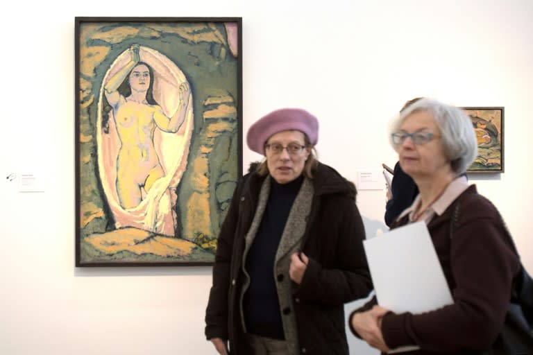 Visitors walk past a painting titled 'Venus in the Grotto' by Koloman Moser at an exhibition devoted to the key figures of the Viennese Modernism