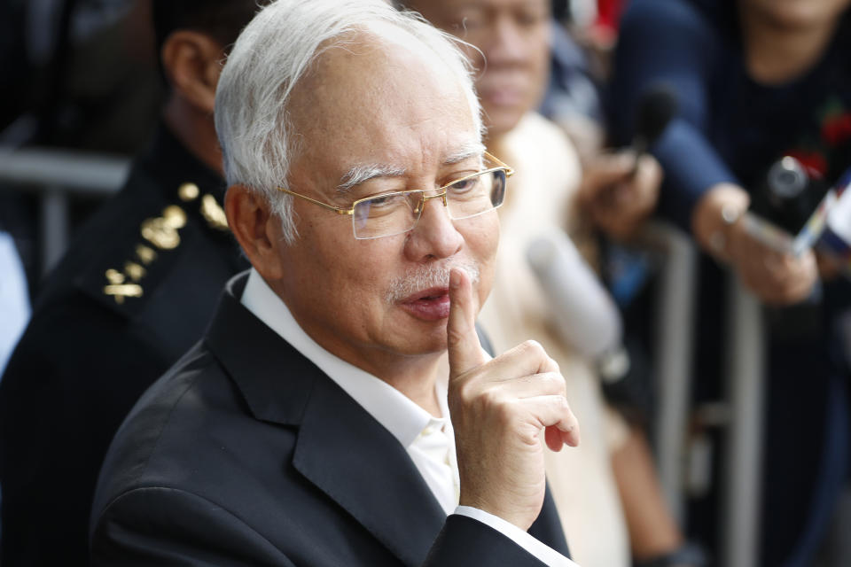 File - In this May 24, 2018, file photo, former Malaysian Prime Minister Najib Razak gestures as he leaves the Malaysian Anti-Corruption Commission (MACC) Office in Putrajaya, Malaysia. After years of insisting on his innocence, Najib learns his fate this week in his first corruption trial linked to one of the world’s biggest financial scandals - a verdict widely seen as a test for the rule of law five months after a new government took power. July 28, 2020's ruling is being closely watched amid a stunning reversal of fortune for Najib’s Malay party, which returned to office as a key player in the new ruling alliance. (AP Photo/Vincent Thian, File)