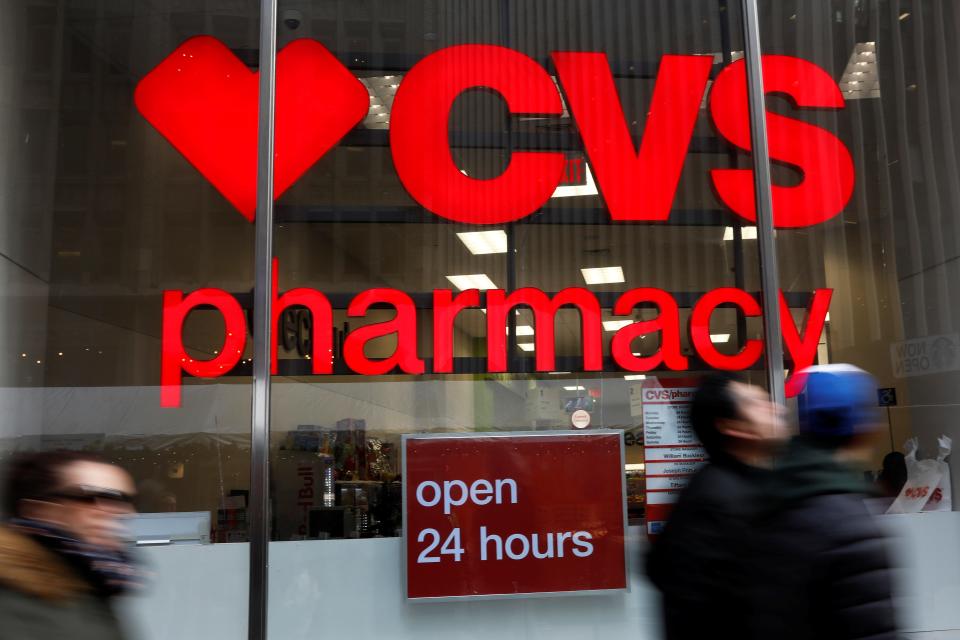 FILE PHOTO: People walk by a CVS Pharmacy store in the Manhattan borough of New York City, New York, U.S., November 30, 2017. REUTERS/Shannon Stapleton